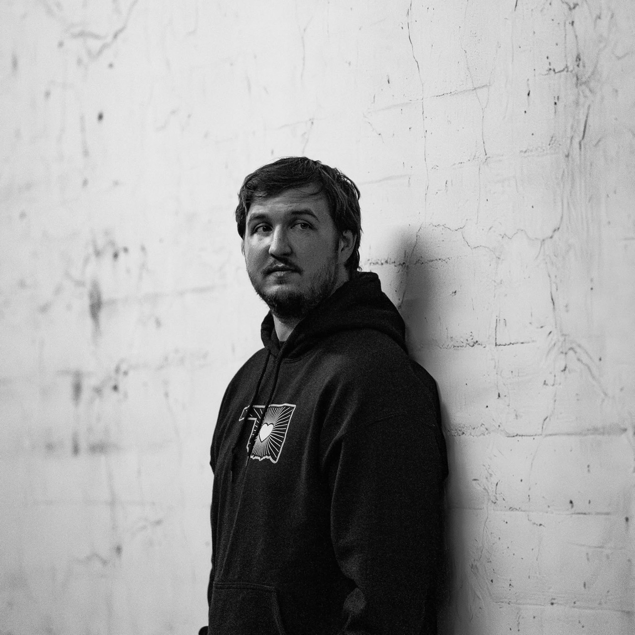Collin Davidson standing against a textured wall